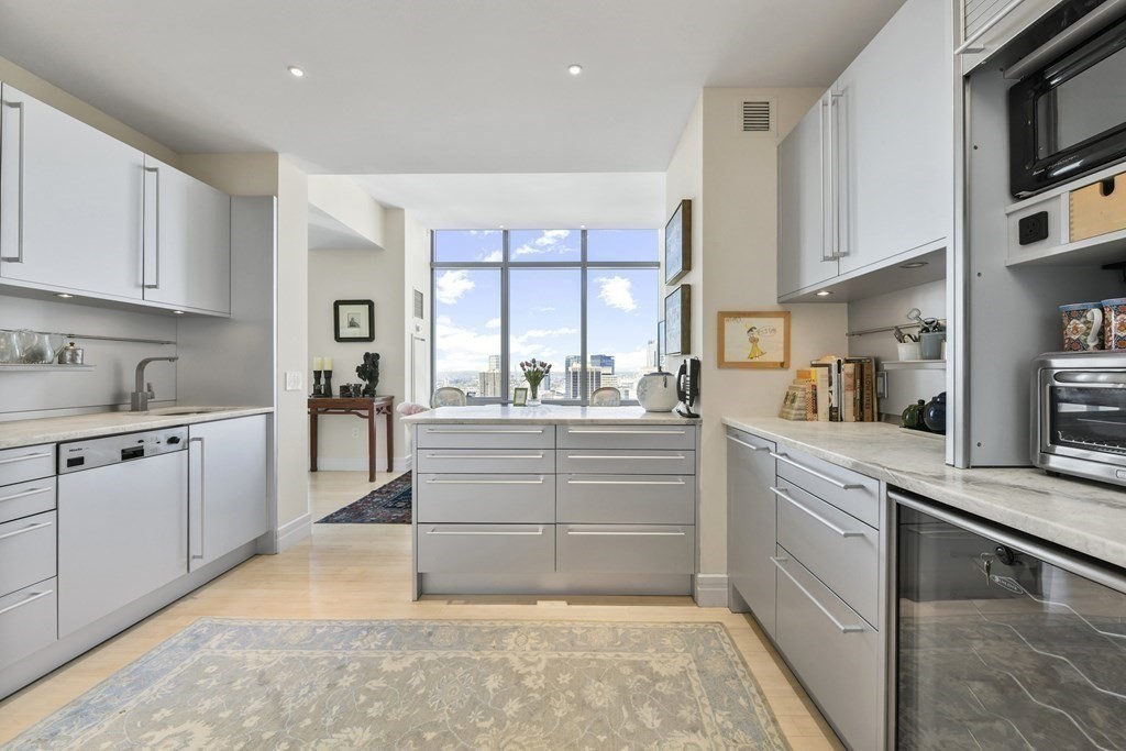 1 Avery Street, Unit PH1A Boston, MA 02111 - Photo 18 of 29 a kitchen with granite countertop white cabinets and white appliances