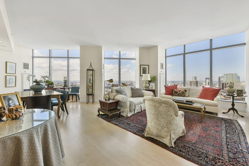 1 Avery Street, Unit PH1A Boston, MA 02111 - Photo 2 of 29 a living room with furniture and a large window
