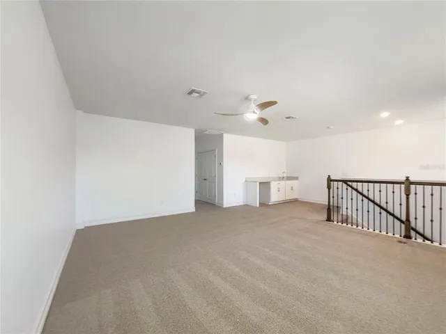 a view of a livingroom with a ceiling fan and window