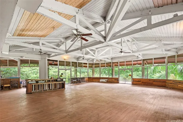 a view of a patio with a table and chairs under an umbrella