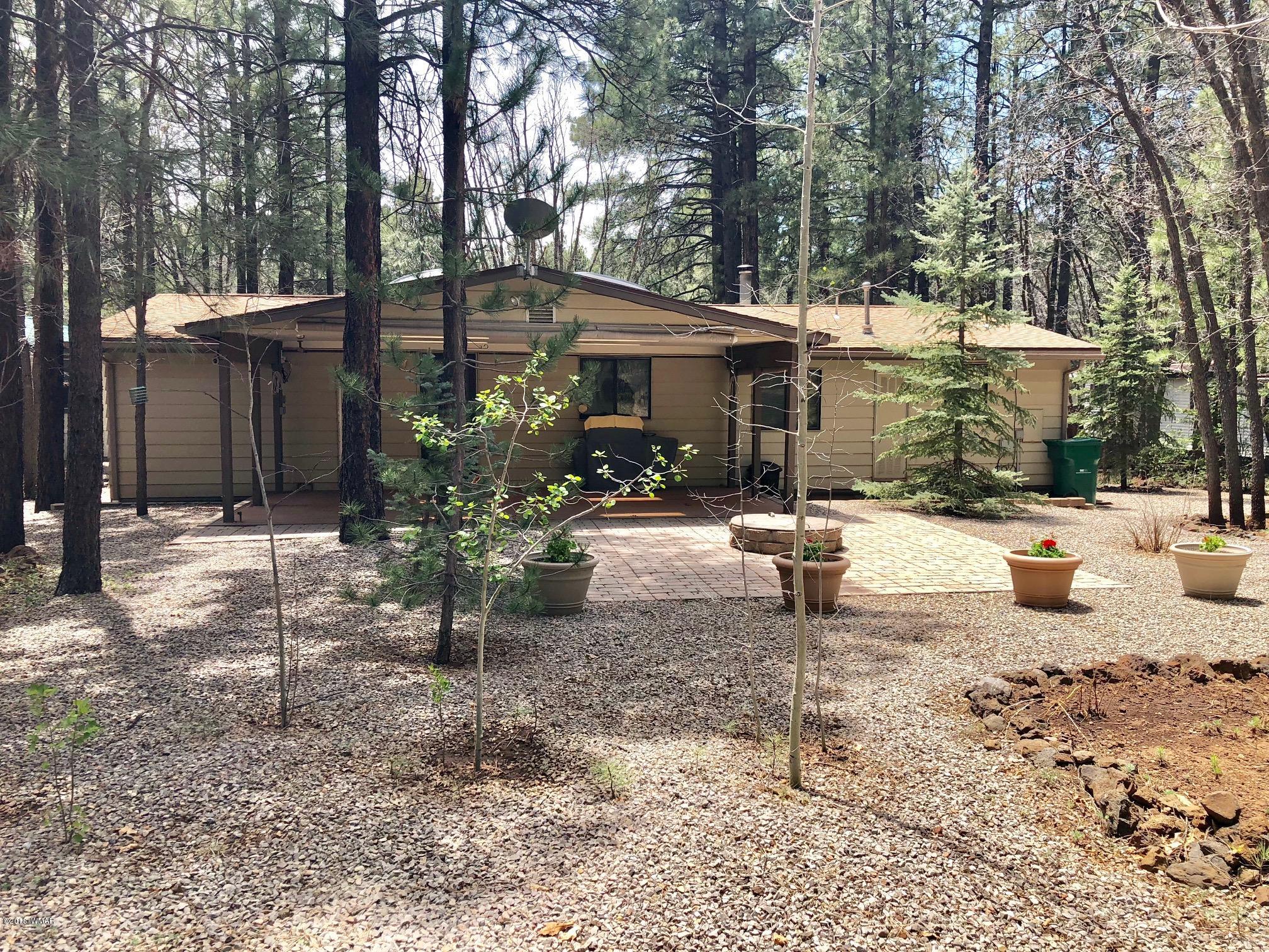 4288 Racoon Court Pinetop, AZ 85935 - Photo 1 of 29 a backyard of a house with table and chairs