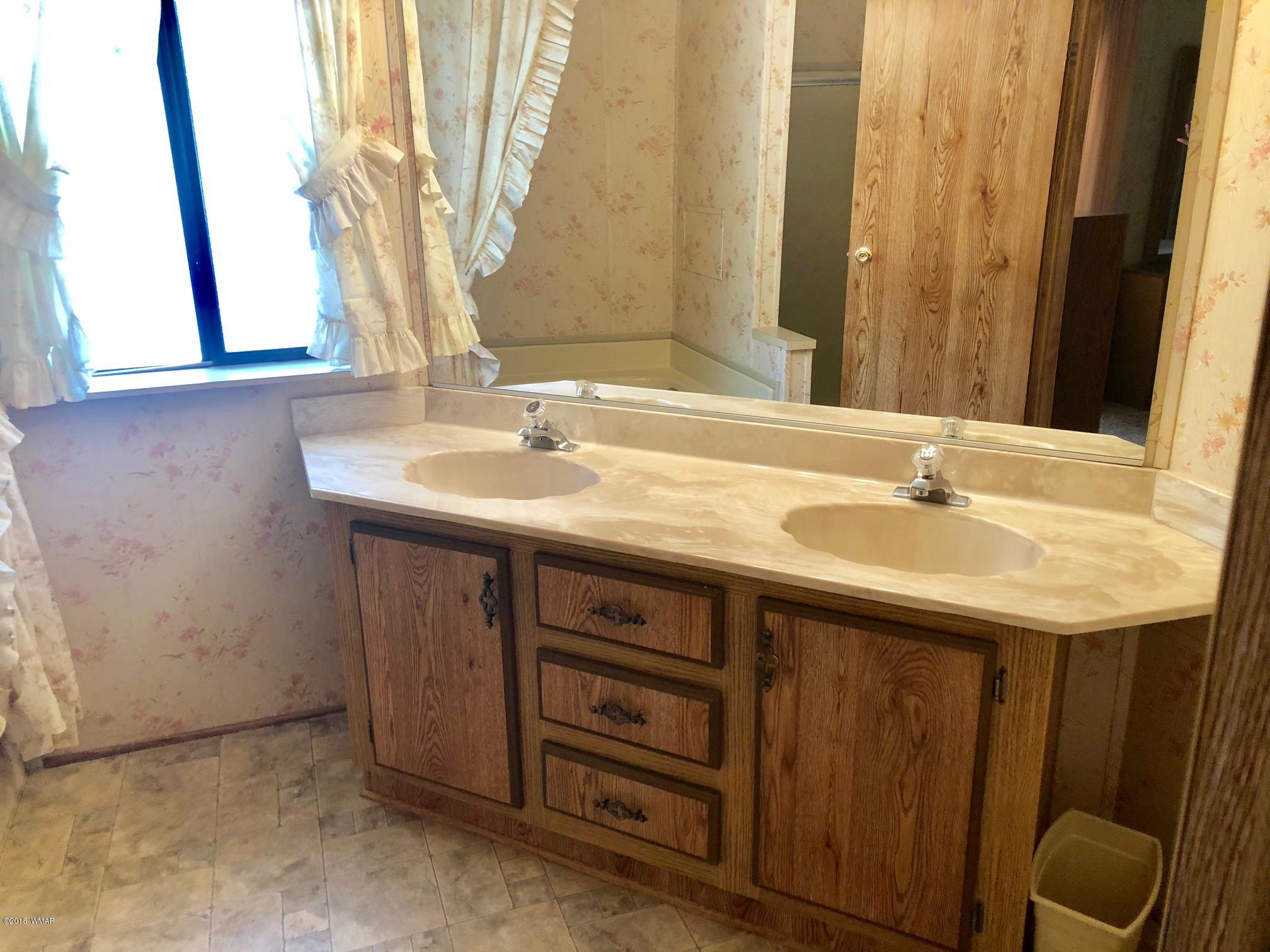 4288 Racoon Court Pinetop, AZ 85935 - Photo 15 of 29 a sink with a vanity and a mirror