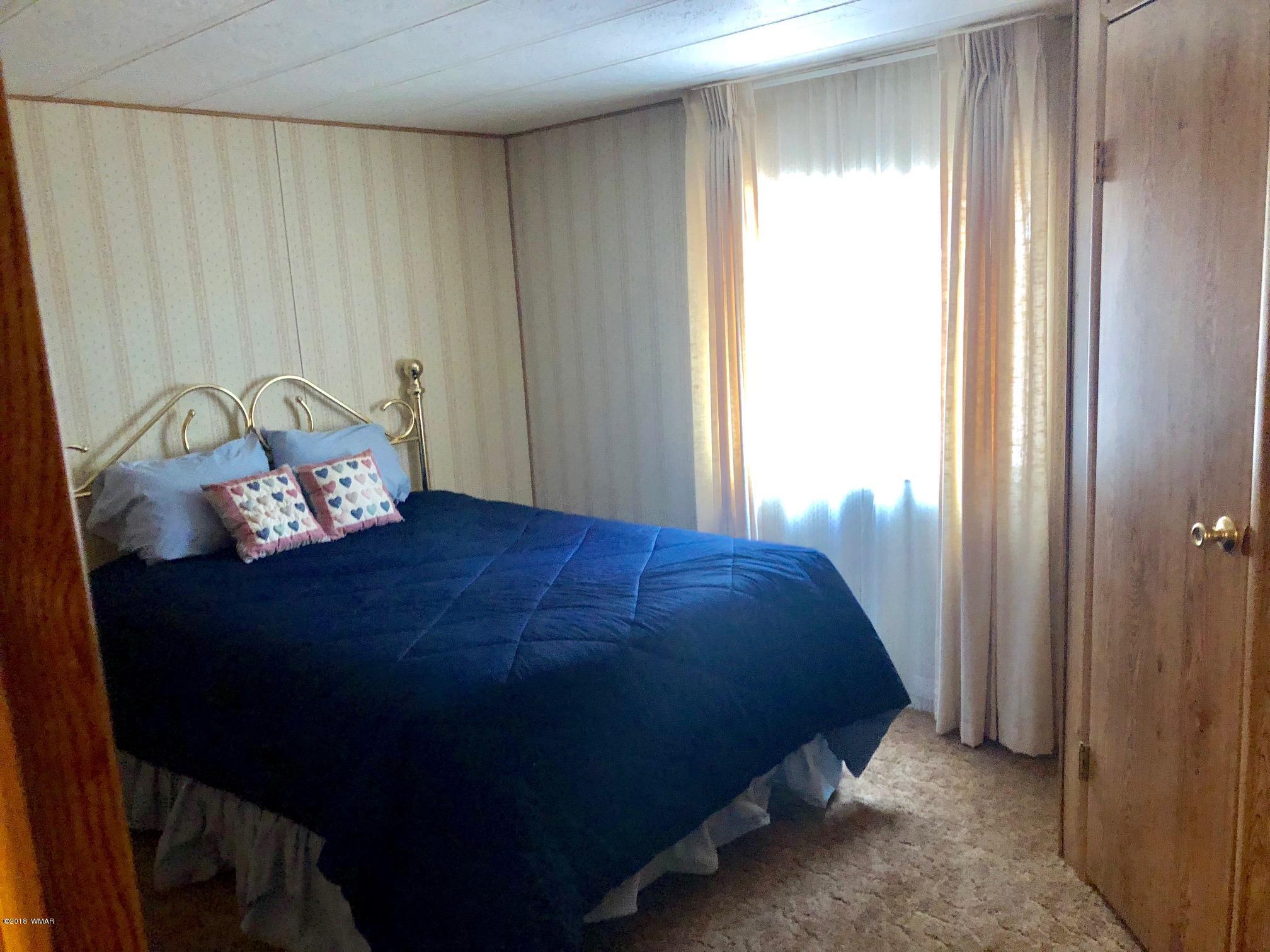 4288 Racoon Court Pinetop, AZ 85935 - Photo 17 of 29 a bedroom with a bed and a window