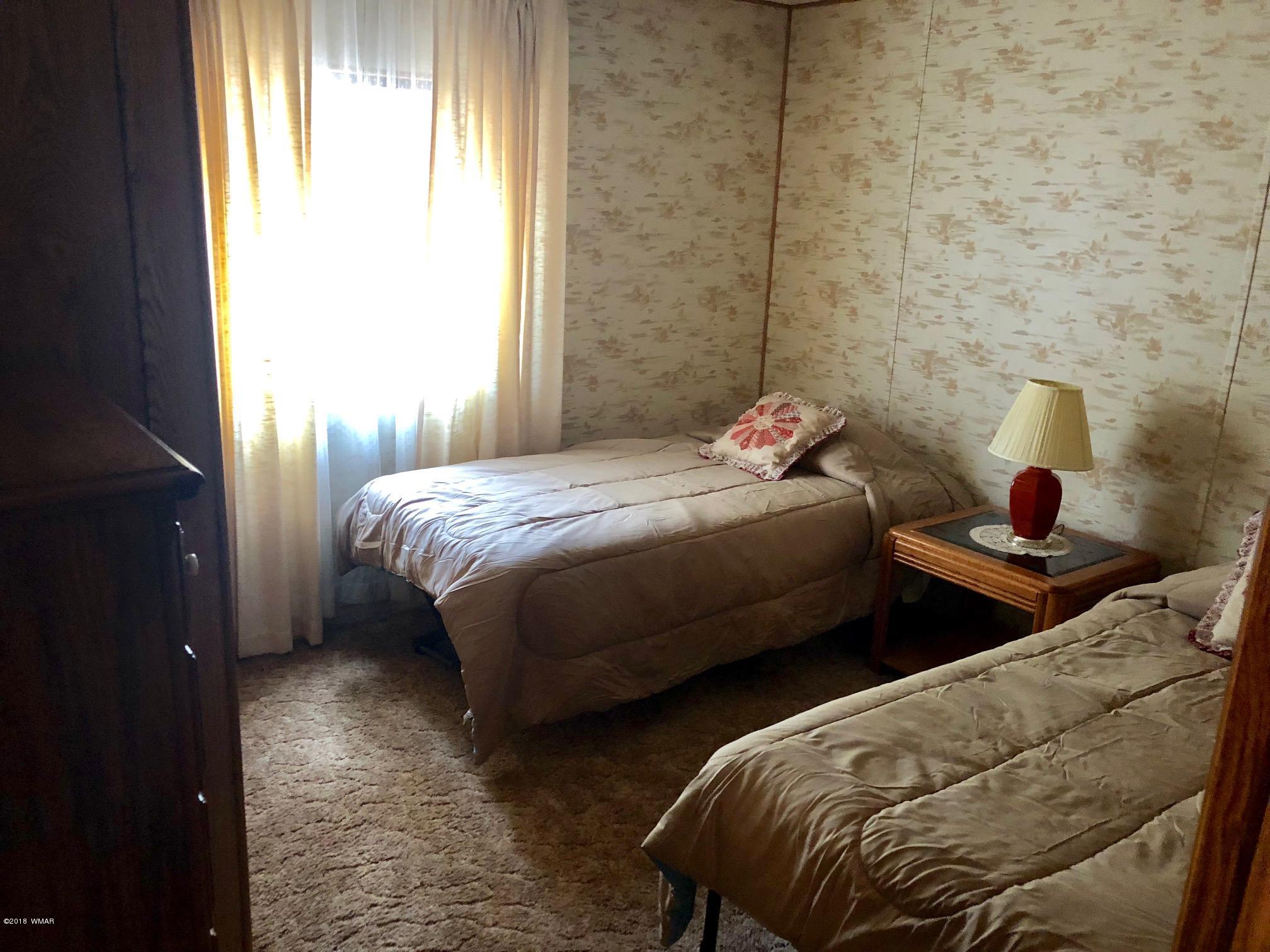 4288 Racoon Court Pinetop, AZ 85935 - Photo 18 of 29 a bedroom with two beds and a window