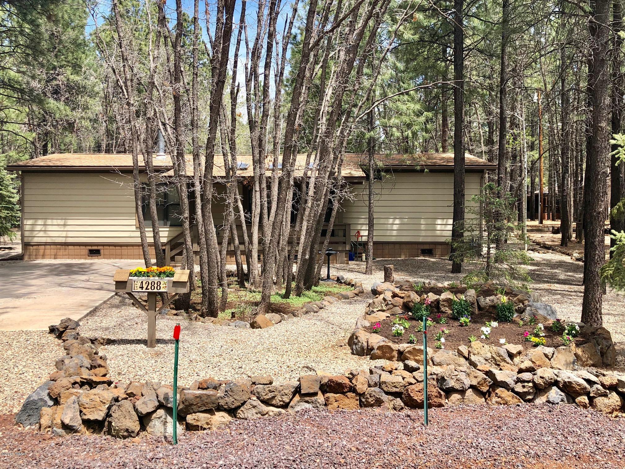 4288 Racoon Court Pinetop, AZ 85935 - Photo 2 of 29 a backyard of a house with table and chairs