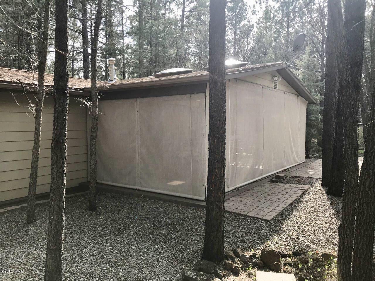 4288 Racoon Court Pinetop, AZ 85935 - Photo 26 of 29 a backyard of a house with a tree