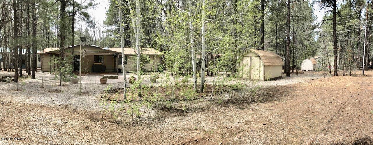 4288 Racoon Court Pinetop, AZ 85935 - Photo 28 of 29 a backyard of a house with lots of green space and tree