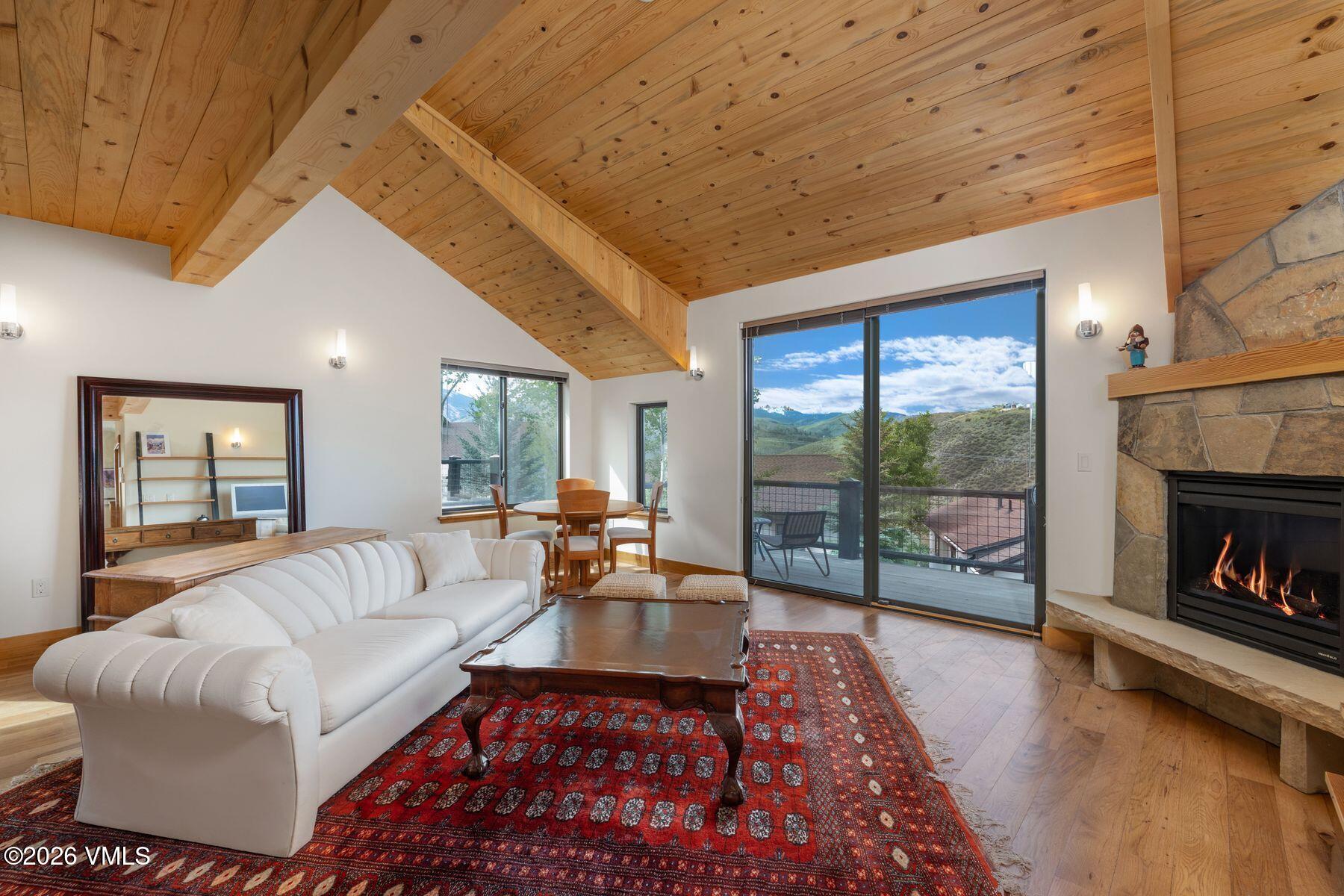 1015 West Wildwood Road, Unit F Avon, CO 81620 - Photo 1 of 35 a living room with furniture and a fireplace