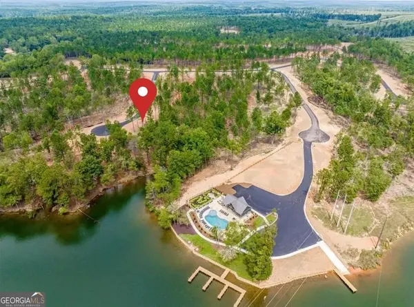 an aerial view of a house with a yard and lake view
