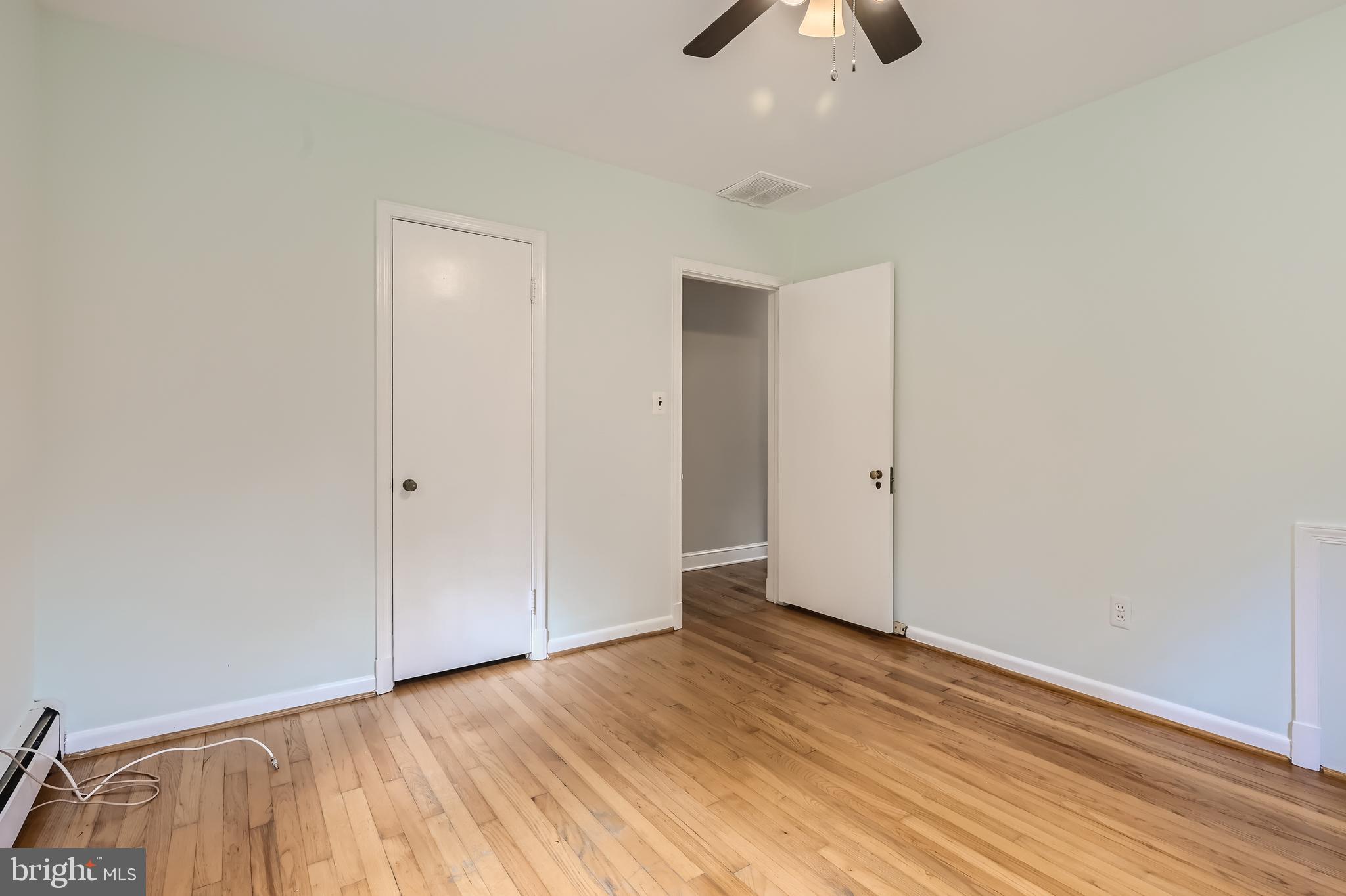 23 Greenspring Valley Road Owings Mills, MD 21117 - Photo 11 of 28 an empty room with ceiling fan and wooden floor