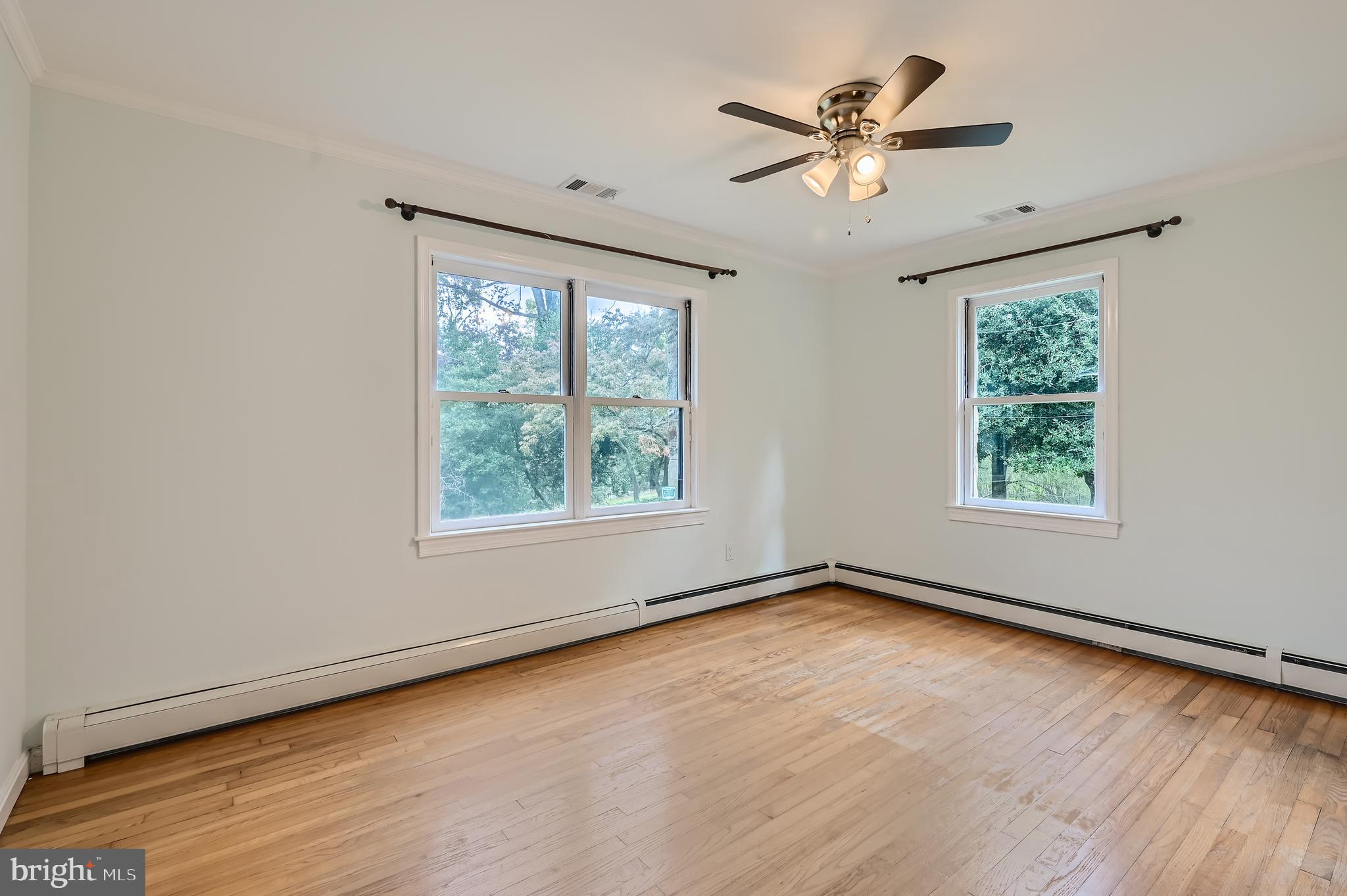 23 Greenspring Valley Road Owings Mills, MD 21117 - Photo 15 of 28 an empty room with wooden floor chandelier fan and windows