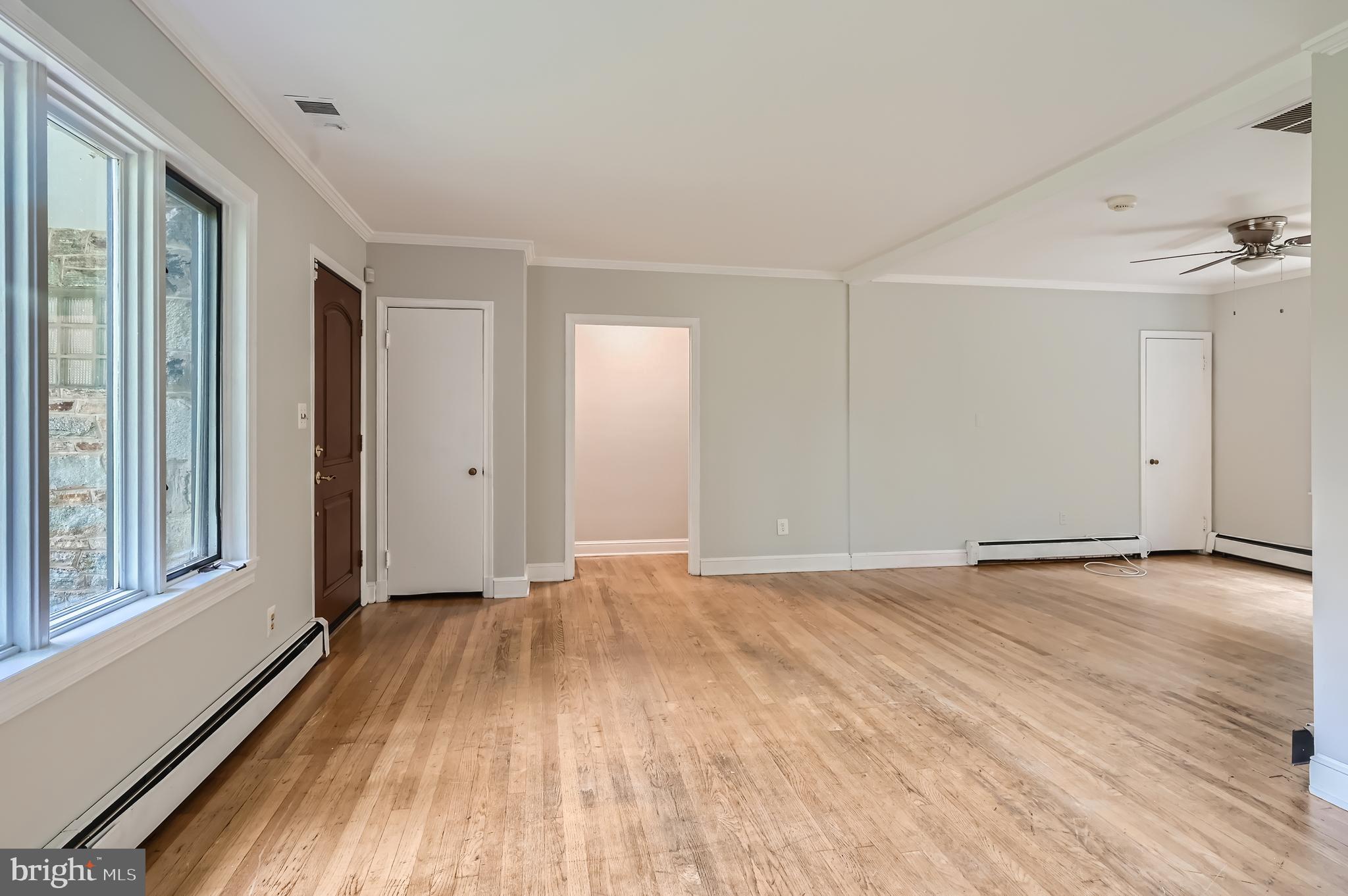 23 Greenspring Valley Road Owings Mills, MD 21117 - Photo 4 of 28 a view of an empty room with wooden floor and a window