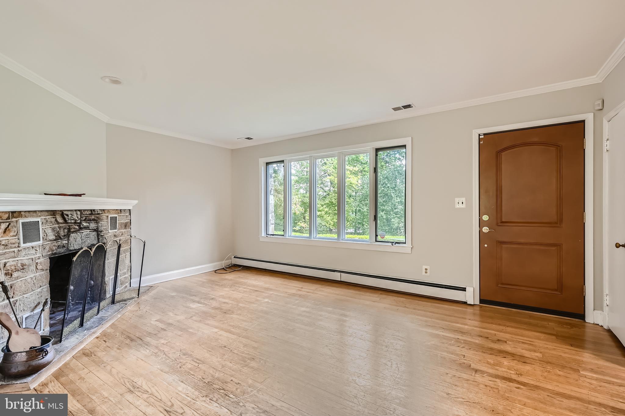 23 Greenspring Valley Road Owings Mills, MD 21117 - Photo 5 of 28 an empty room with fireplace cabinet and windows