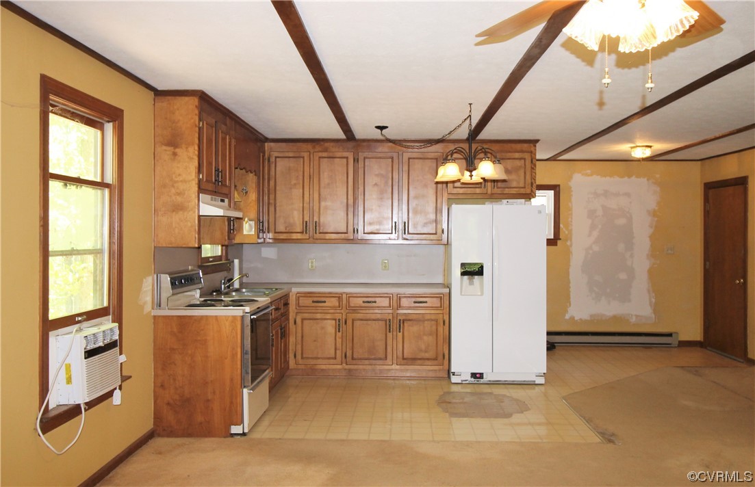 232 Perkins Mill Road Dillwyn, VA 23936 - Photo 27 of 48 a kitchen with stainless steel appliances granite countertop a refrigerator a sink dishwasher a stove and a dining table with wooden floor