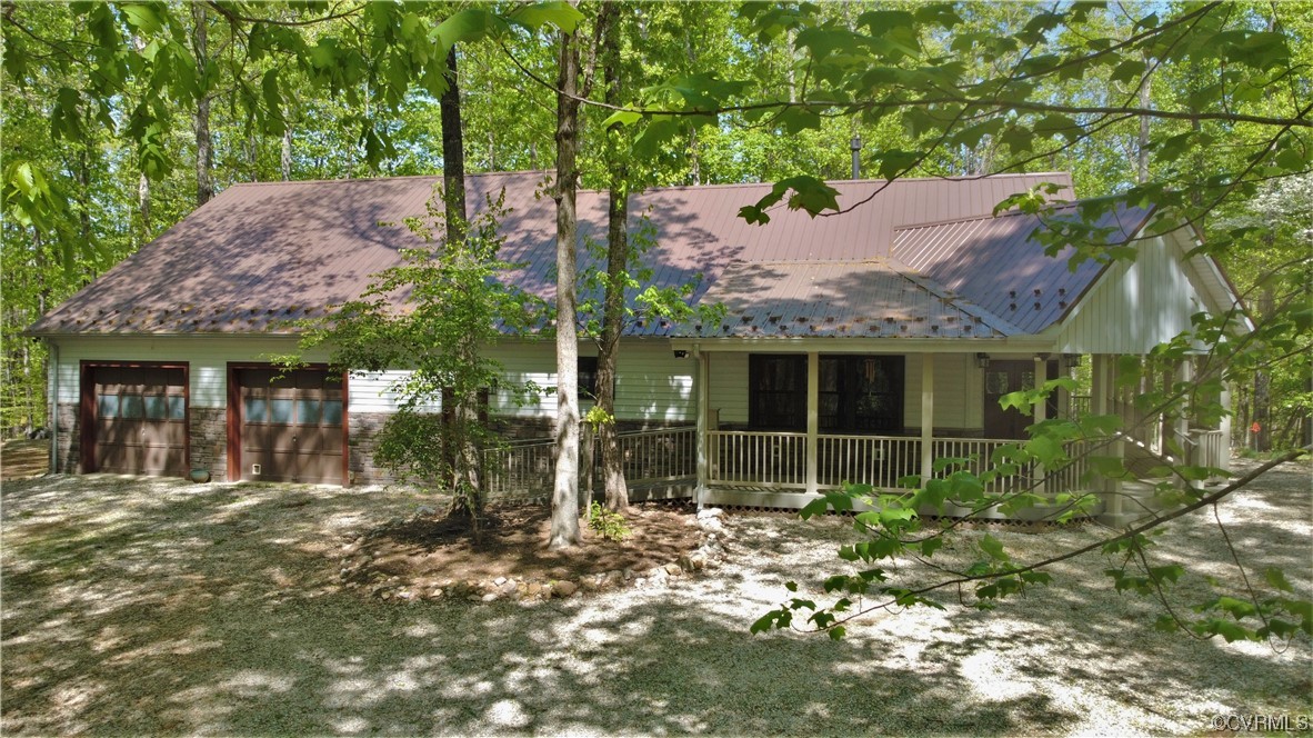 232 Perkins Mill Road Dillwyn, VA 23936 - Photo 4 of 48 a house with lots of trees in the background