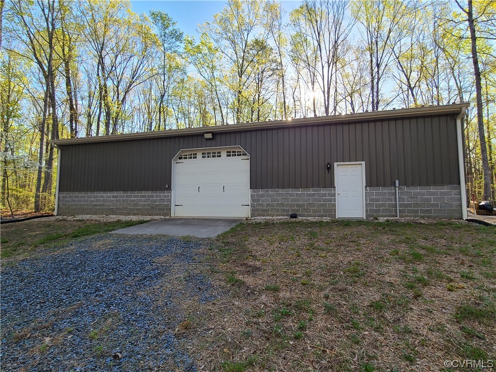 232 Perkins Mill Road Dillwyn, VA 23936 - Photo 44 of 48 a backyard of a house with a large tree and wooden fence