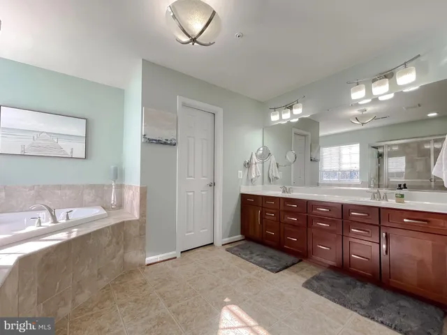 a bathroom with a sink double vanity and a mirror