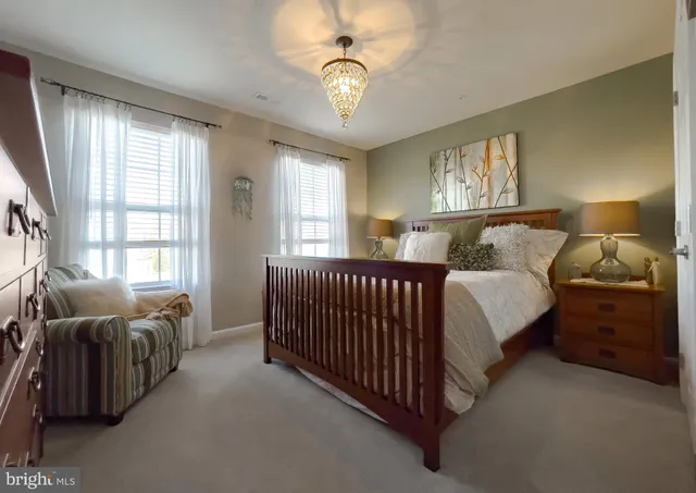a view of a house next to a big yard and large trees