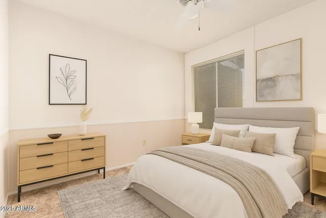 an empty room with a window and a fan