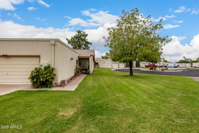 a view of a house with a backyard