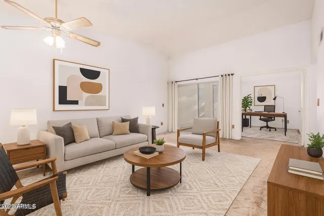 an empty room with a ceiling fan and a window