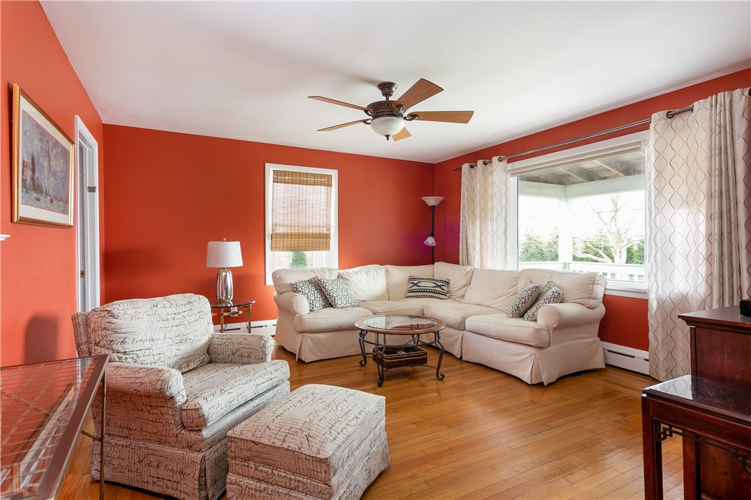 459 Wapping Road Portsmouth, RI 02871 - Photo 7 of 38 The first floor features a living room with hardwood flooring and large windows facing east
