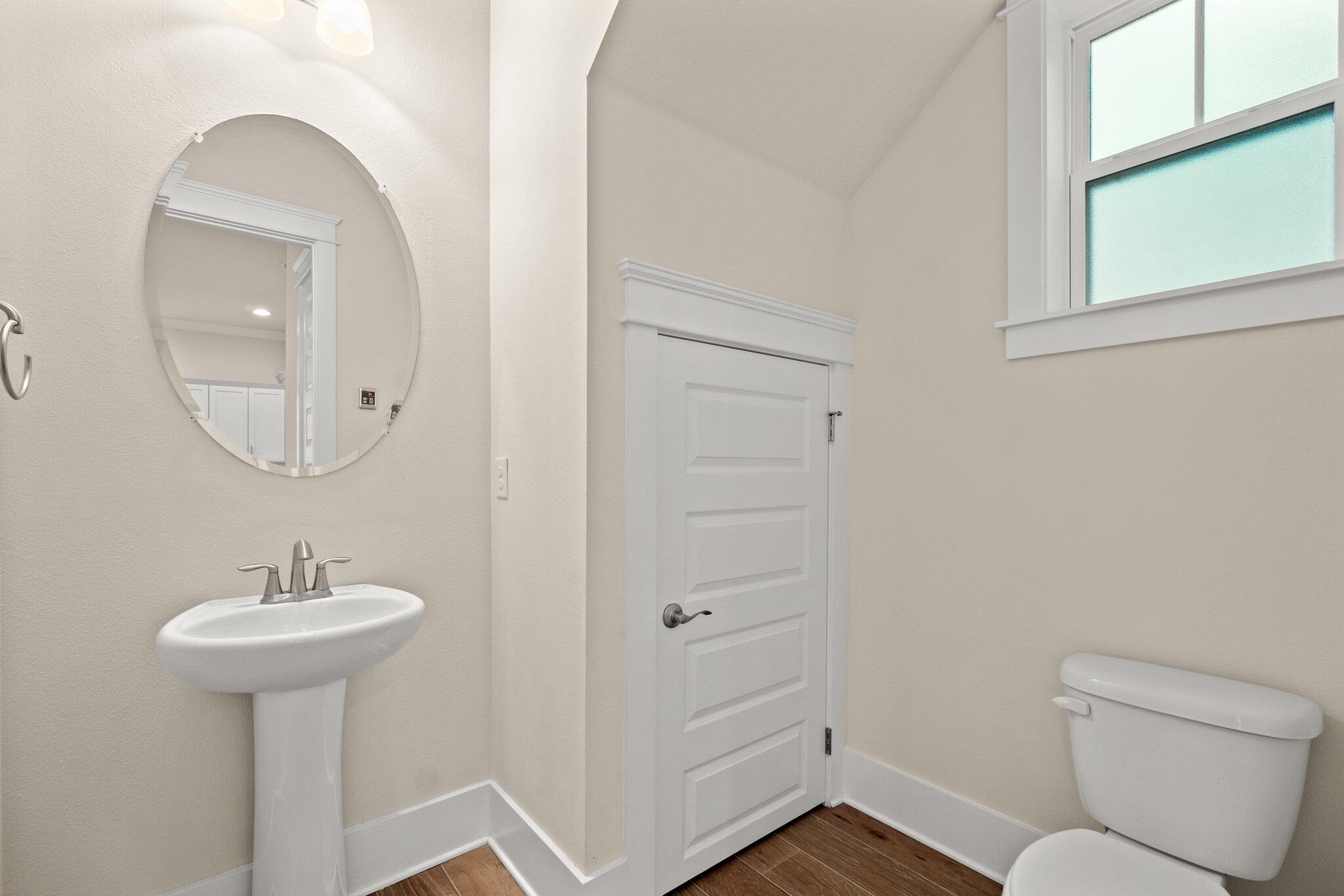 99 Grande Pointe Circle Inlet Beach, FL 32461 - Photo 14 of 34 a bathroom with a sink toilet and a mirror