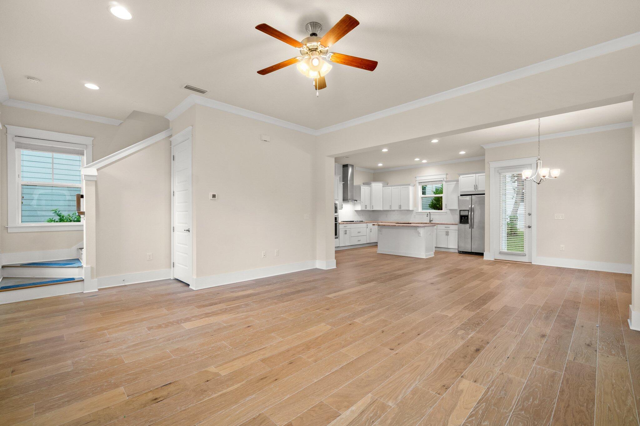99 Grande Pointe Circle Inlet Beach, FL 32461 - Photo 4 of 34 a view of an empty room and kitchen with wooden floor