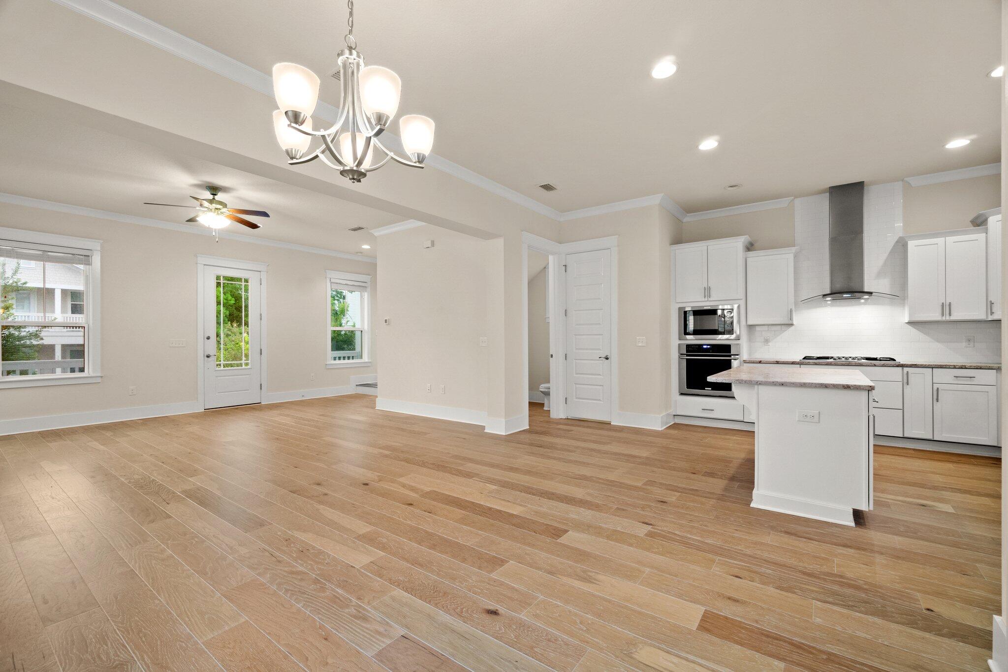 99 Grande Pointe Circle Inlet Beach, FL 32461 - Photo 7 of 34 a view of a big room with chandelier and wooden floor