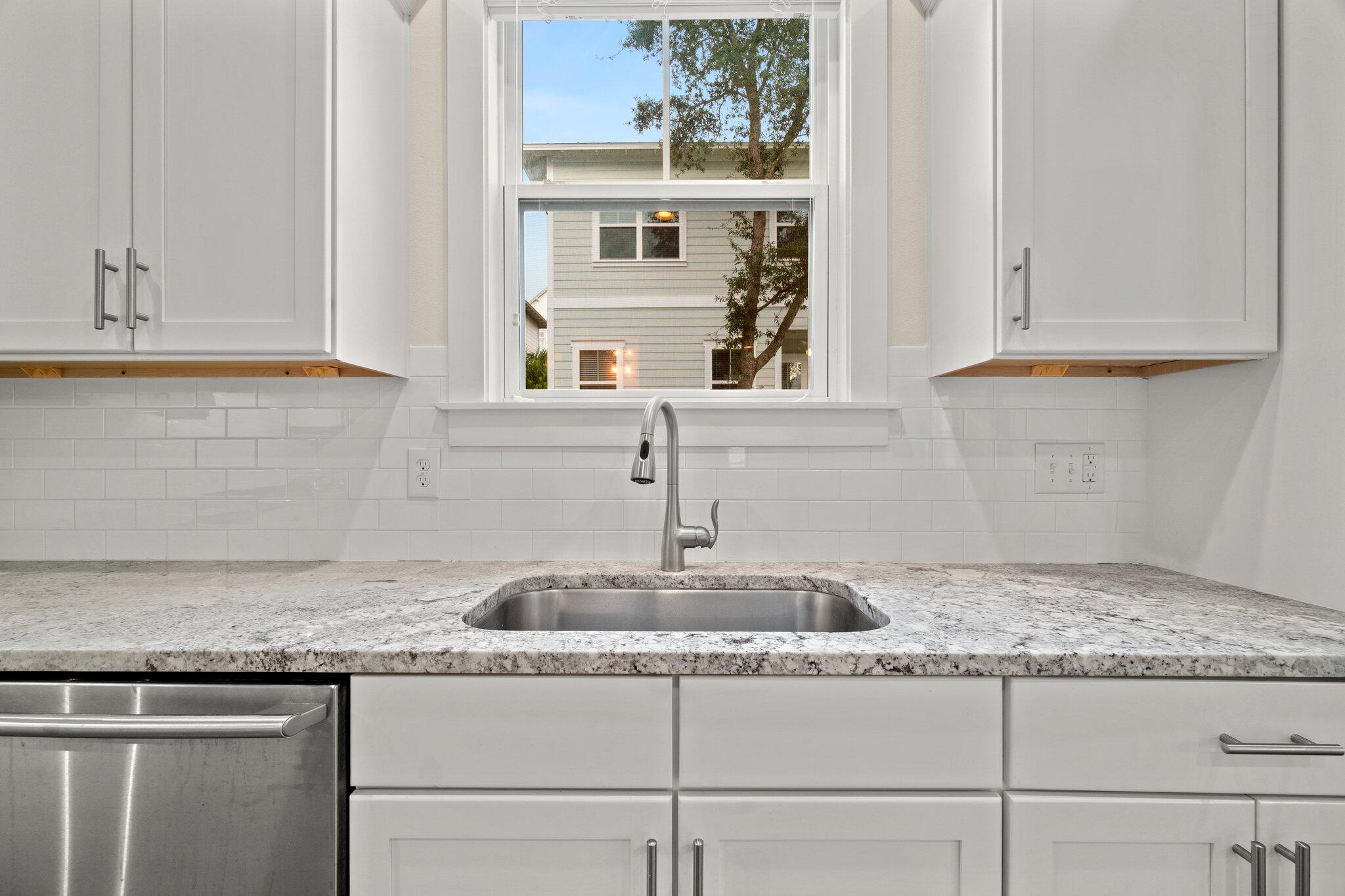 99 Grande Pointe Circle Inlet Beach, FL 32461 - Photo 9 of 34 a kitchen with granite countertop a sink and cabinets