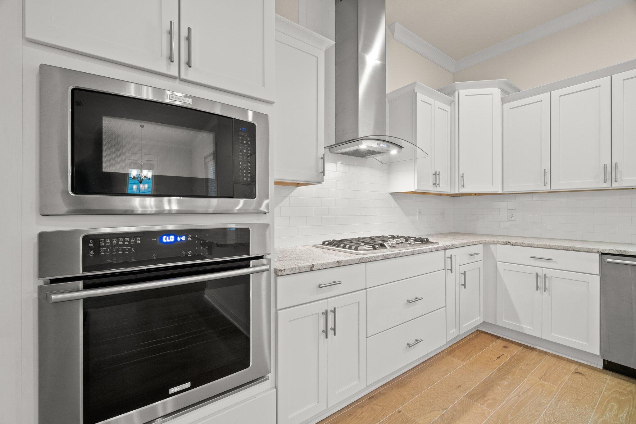 99 Grande Pointe Circle Inlet Beach, FL 32461 - Photo 10 of 34 a kitchen with white cabinets stainless steel appliances and sink