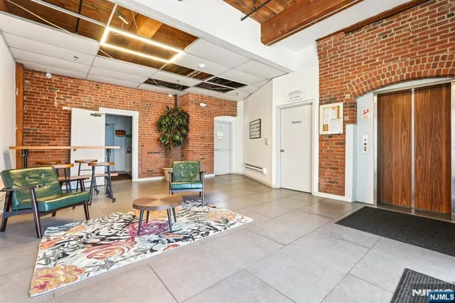 a living room with furniture and a book shelf
