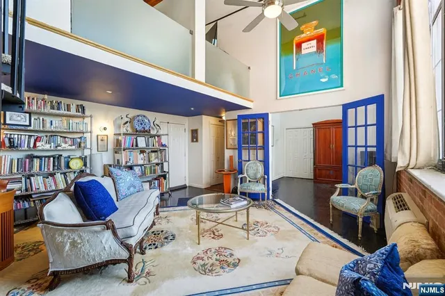 a living room with furniture and floor to ceiling windows