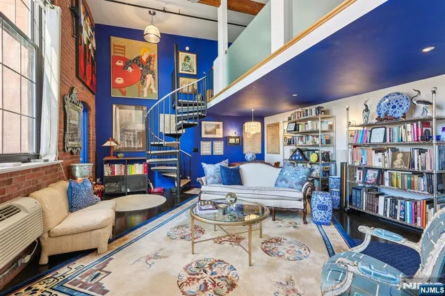 a view of a dining room with furniture and a chandelier