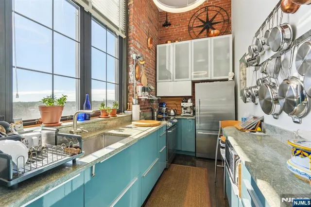 a kitchen with sink and view of living room