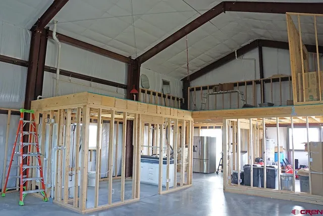 a view of a kitchen with refrigerator and wooden floor