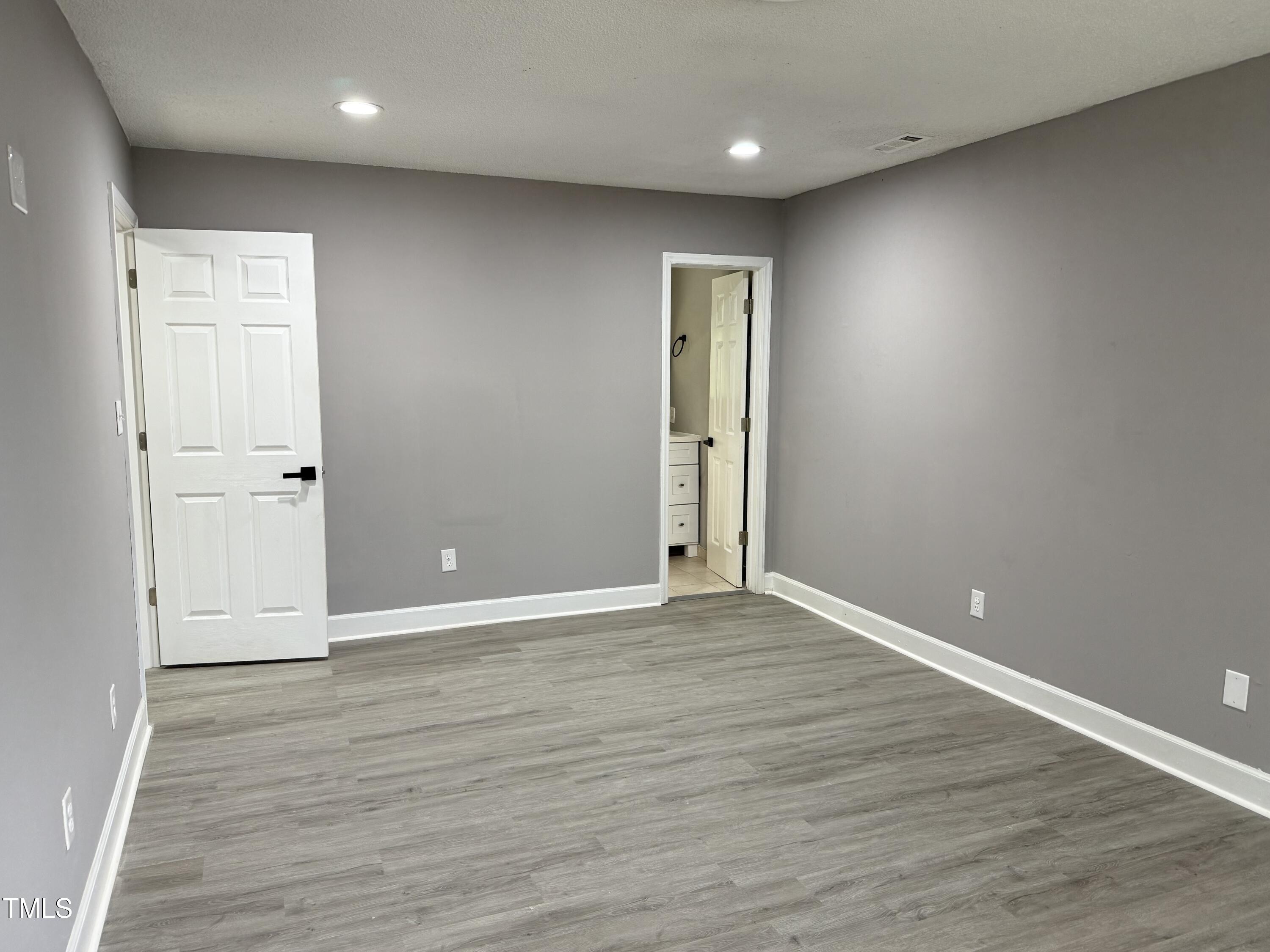 3825 Old Coach Road Raleigh, NC 27616 - Photo 16 of 31 an empty room with wooden floor and windows