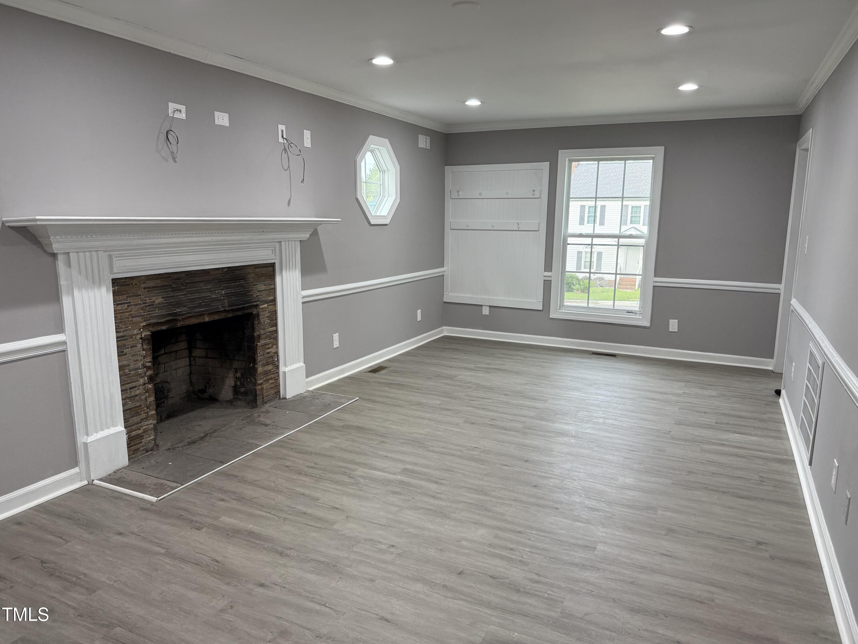 3825 Old Coach Road Raleigh, NC 27616 - Photo 3 of 31 an empty room with wooden floor and fireplace