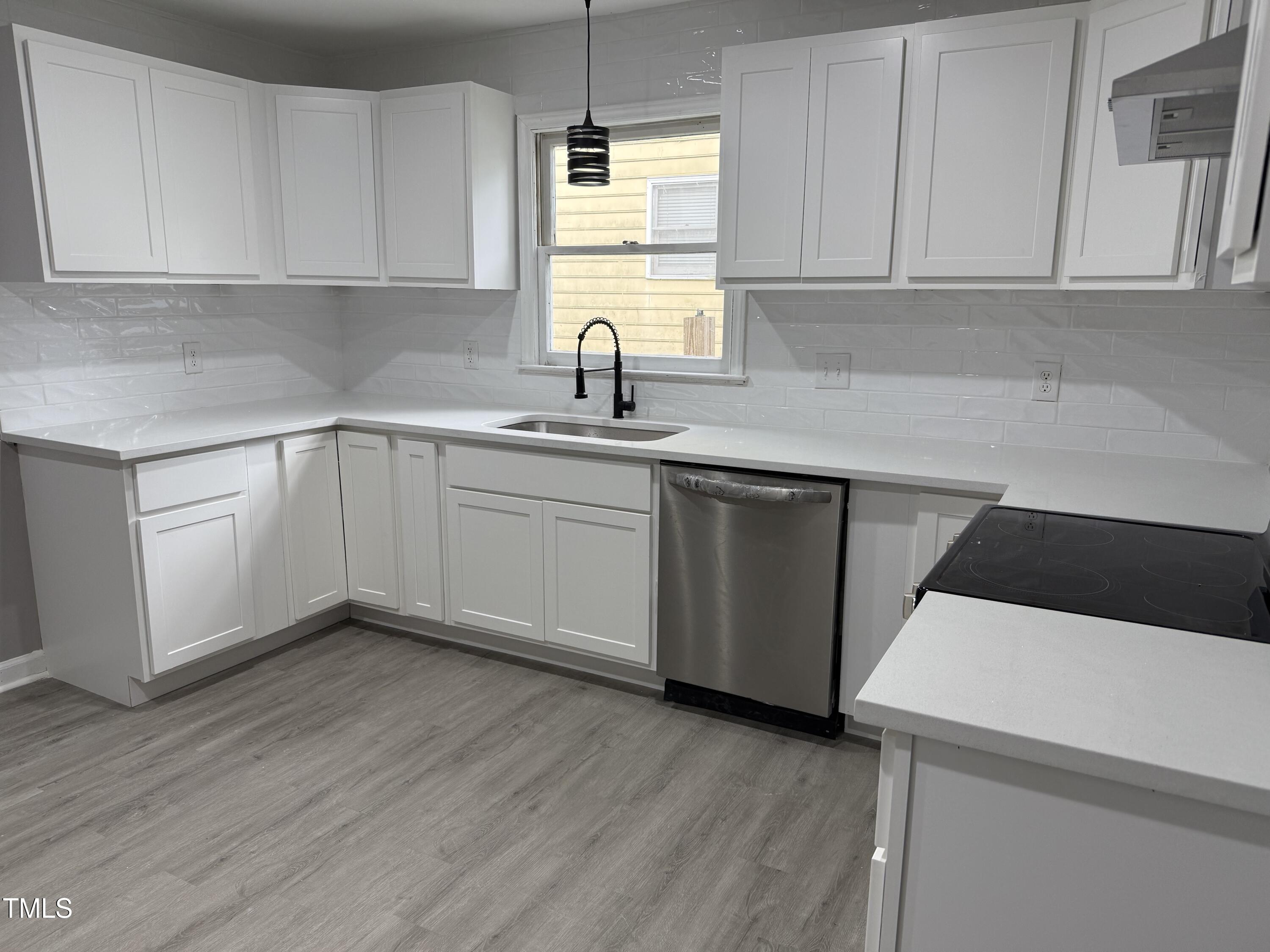 3825 Old Coach Road Raleigh, NC 27616 - Photo 8 of 31 a kitchen with a sink cabinets and window