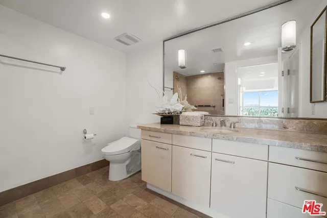 a bedroom with a bed and a night stand