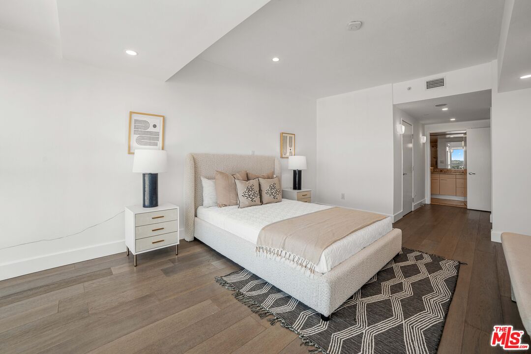 13600 Marina Pointe Drive, Unit 1904 Marina del Rey, CA 90292 - Photo 17 of 57 a bedroom with a bed and wooden floor
