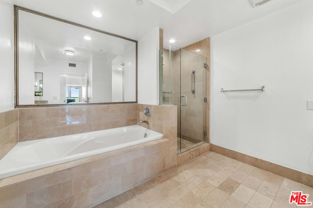 13600 Marina Pointe Drive, Unit 1904 Marina del Rey, CA 90292 - Photo 21 of 57 a spacious bathroom with a bathtub and a shower