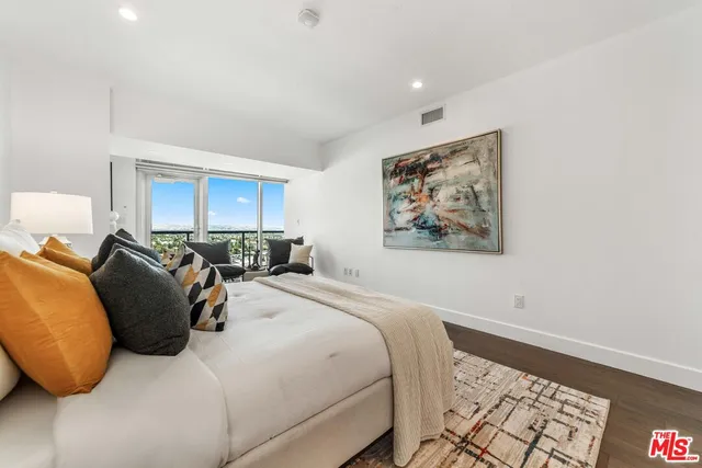 a bedroom with furniture and wooden floor