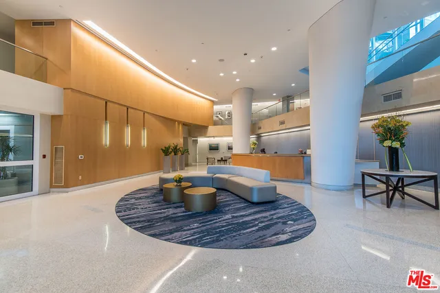 a living room with furniture and kitchen view