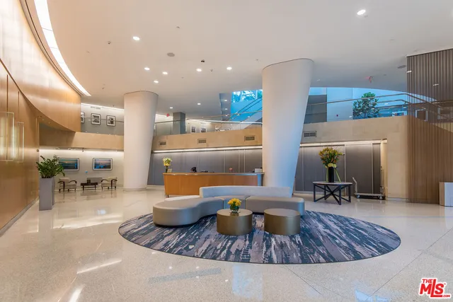 a lobby with furniture and a potted plant