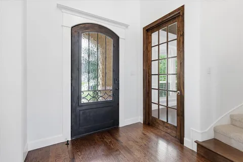 an empty room with wooden floor and a window
