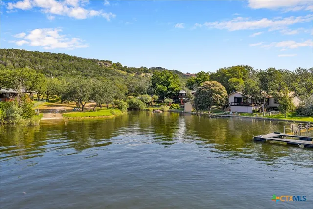 a view of a lake with houses in the back