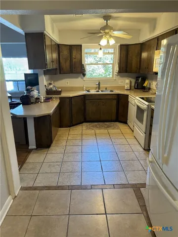 a large kitchen with cabinets and a window