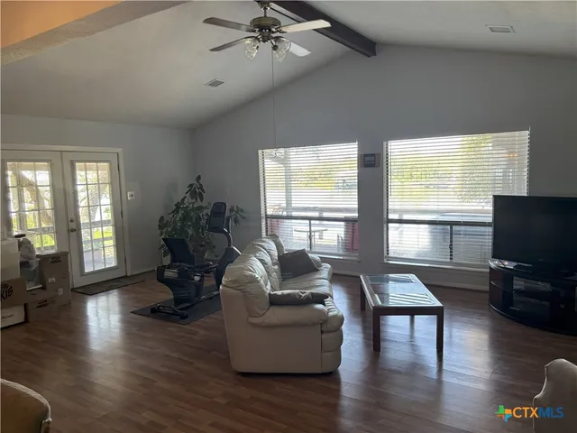 a living room with furniture window and wooden floor
