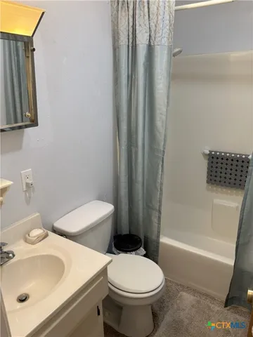 a white toilet sitting next to a bathroom sink